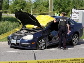 Police investigate a serious car crash between an Ottawa police car and a blue VW Jetta at the intersection of Hazeldean Rd and Huntmar in  the West end of Ottawa on June 04, 2015.