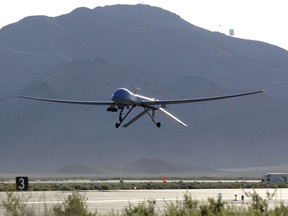 An MQ-1 Predator unmanned aerial vehicle takes off from Creech Air Force Base, Nev., May 11, for a training sortie over the Nevada desert.  Four Predators from the 432nd Wing are ready to deploy, if needed, to help in humanitarian relief efforts in Missouri. (U.S. Air Force photo/Staff Sgt. Brian Ferguson)