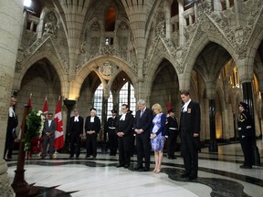 Prime Minister Stephen Harper, his wife, Laureen, along with House of Commons Speaker Andrew Scheer, and members of the Commons staff and family members impacted by acts terror, stand for a moment of silence during a wreath laying ceremony marking the National Day of Remembrance for Victims of Terrorism in the Hall of Honour on Parliament Hill.