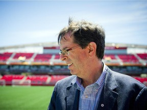 Roger Greenberg, chair of the Ottawa Sports and Entertainment Group, speaks with a reporter at the official announcement that the redevelopment of Lansdowne Park is complete.