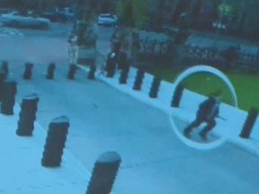 A still from RCMP surveillance video on Parliament Hill from October 22, 2014, shows Michael Zehaf-Bibeau running toward the Centre Block.