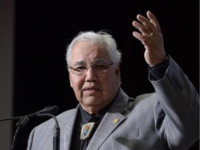 Commission chairman Justice Murray Sinclair raises his arm asking residential school survivors to stand at the Truth and Reconciliation Commission in Ottawa on Tuesday, June 2, 2015.