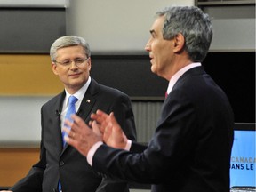 Prime Minister Stephen Harper looks on as Liberal Leader Michael Ignatieff speaks during the French language federal election debate in Ottawa on Wednesday, April 13, 2011.