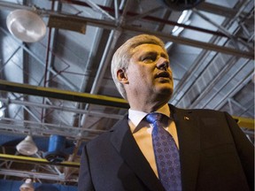 Prime Minister Stephen Harper greets guests after making a policy statement in Toronto on June 18, 2015.