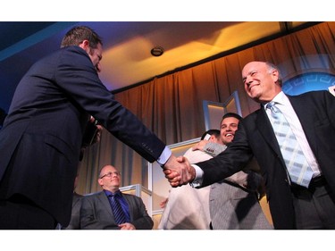 "Stuntman Stu" Schwartz gives a good-bye handshake to Russell Kronick during the elimination draw for $30,000 in prize money, held during the Hellenic Community's 30th Annual Gold Plate Dinner held at the Hellenic Meeting and Reception Centre on Tuesday, June 9, 2015.