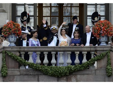 Sweden's Princess Sofia, third from right, together with Sweden's Prince Carl Philip, third from left, wave to the crowd after their wedding ceremony next to the bridegroom's parents Sweden's King Carl XVI Gustaf (L) and Sweden's Queen Silvia (2nd L) and the bride's parents  Marie Hellqvist (2nd R) and Erik Hellqvist at Stockholm Palace on June 13, 2015.
