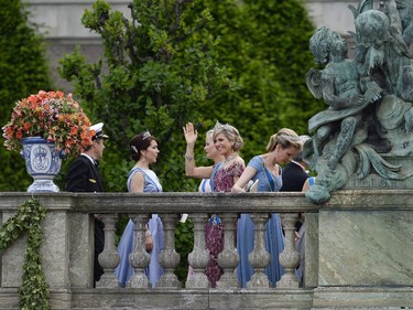 Queen Maxima of the Netherlands (C) waves outside the Stockholm Palace after the wedding ceremony of Sweden's Crown Prince Carl Philip and Sofia Hellqvist on June 13, 2015.