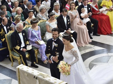 Sweden's Prince Carl Philip and Sofia Hellqvist stand at the altar during their wedding in the Royal Chapel in Stockholm, Sweden, Saturday, June 13, 2015. In the background are Sweden's King Carl Gustaf, Queen Silvia, Coriwn Princess Victoria, Prince Daniel Princess Madeleine.