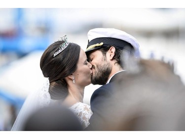 Sweden's  Prince Carl Philip kisses his bride, Sofia Hellqvist in a carriage, after their wedding ceremony,  in Stockholm, Sweden,  Saturday, June 13, 2015.  The only son of King Carl XVI Gustaf and Queen Silvia has married his Swedish fiancee in a lavish ceremony in Stockholm. Prince Carl Philip and the former reality starlet and model Sofia Hellqvist, 30, tied the knot Saturday at the Royal Palace chapel before five European queens, a Japanese princess and dozens of other blue-blooded guests. The couple engaged in June 2014.