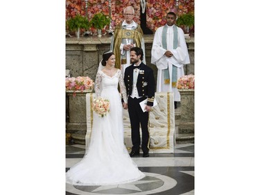 Sweden's  Prince Carl Philip stand with his bride, Sofia Hellqvist at the altar during their  wedding ceremony