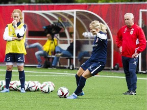 Norway's Lene Mykjaland kicks the ball on goal while head coach Even Pellerud, right, looks on during  a recent practice.