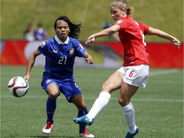 Thailand's Kanjana Sung-Ngoen (21) challenges Norway's Maren Mjelde (6) for the ball during the first half of their first match of the FIFA Women's World Cup at TD Place in Ottawa Sunday June 07, 2015.
