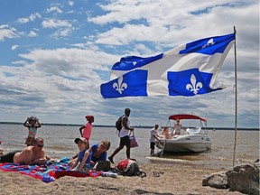 Files: The Quebec flag was proudly displayed on the beach at Parc des Cédres in Aylmer along the Ottawa River to celebrate St. Jean Baptiste day, June 24, 2015.