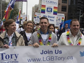 Patrick Brown, centre, walks the route during Toronto's Pride Parade on Sunday June 28, 2015. After winning the Progressive Conservative leadership.
