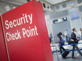 A sign directs travelers to a security checkpoint.