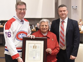 Dr. Safaa Fouda receives the Mayor's City Builder Award from Mayor Jim Watson, left, and Beacon Hill-Cyrville Ward Coun. Tim Tierney.