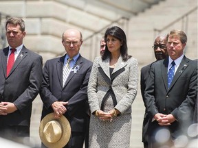 South Carolina Governor Nikki Haley (C) watches as the casket holding  Emanuel AME Church pastor and South Carolina State Sen. Clementa Pinckney as it arrives at the steps of the South Carolina State House in Columbia, South Carolina, on June 24, 2015.
