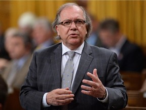 Aboriginal Affairs Minister Bernard Valcourt answers a question during Question Period in the House of Commons in Ottawa on Monday.