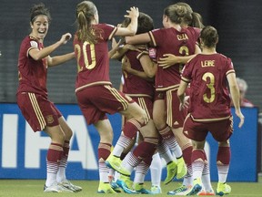 Players from team Spain celebrate a goal.
