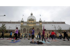 Yoga practitioners take part in a free morning yoga session at Lansdowne Park next to the Aberdeen Pavilion in Ottawa on Saturday, October 18, 2014.