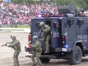 Before its famous Sunset Ceremony, out came members of the fRCMP's Emergency Response Team in two vehicles for a mock takedown of two bad guys, with flashing lights and screaming sirens, smoke bombs, possibly a stun grenade, and the appearance of a black armoured vehicle.