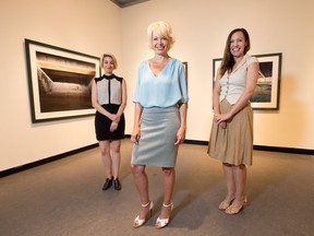 The Ottawa Art Galllery, from left, rental and sales manager Stephanie Germano, director Alex Badzak, and curator Ola Wlusek, photographed in an exhibition of work by Lynne Cohen. Senior curator Catherine Sinclair is on maternity leave. (Wayne Cuddington / Ottawa Citizen)