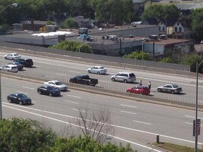 People walk along the Queensway following a multi-vehicle crash Wednesday.