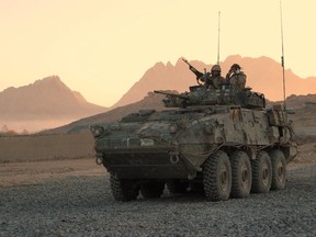 A Canadian light armoured vehicle arrives to escort a convoy at a forward operating base near Panjwaii, Afghanistan,  on Nov. 26, 2006.