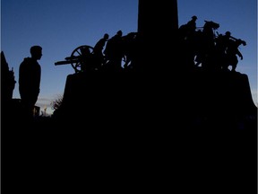 A soldier stands guard at dusk at the National War Memorial.