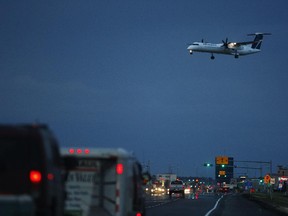 A Westjet Bombardier Q400 airplane crosses over 100 Avenue just before landing at Grande Prairie Airport on Wednesday July 22, 2015 in Grande Prairie, Alta.