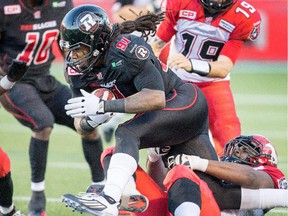 Aston Whiteside scrambles with the ball after a fumble as the Ottawa Redblacks take on the Calgary Stampeders in CFL action at TD Place stadium.