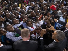 In this Sunday, July 26, 2015 file photo, President Barack Obama shakes hands with the crowd after delivering a speech at the Safaricom Indoor Arena in Nairobi, Kenya.  President Barack Obama's historic visit to Kenya and Ethiopia, which concluded Tuesday July 28, 2015, was marked by stirring images of throngs of thousands coming out to cheer the motorcade for this first visit by a sitting American president.