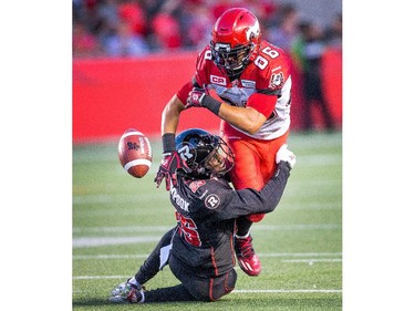 Brandyn Thompson, left, causes Anthony Parker of Calgary to fumble the ball in the second quarter.