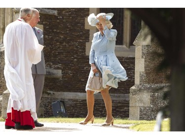 Camilla, The Duchess of Cornwall battles with the wind as she attends Princess Charlotte of Cambridge's Christening at St. Mary Magdalene Church in Sandringham, England, on July 5, 2015. Crowds gathered outside Queen Elizabeth II's country residence on Sunday for the christening of Britain's baby Princess Charlotte, who it was announced will have five godparents.
