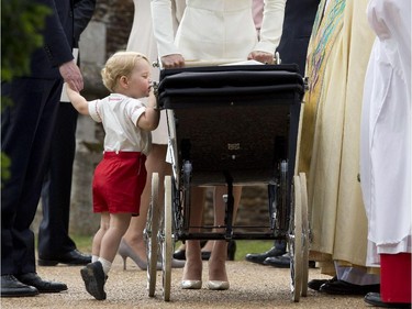 "Hi, sister Charlie!" Prince George of Cambridge looks at his sister as his mother, Britain's Catherine, Duchess of Cambridge, father Prince William, Duke of Cambridge (L), and Archbishop of Canterbury Justin Welby (2nd R) look on, as they leave Charlotte's Christening at St. Mary Magdalene Church in Sandringham, England, on July 5, 2015. Britain's baby Princess Charlotte was christened on Sunday outside Queen Elizabeth II's country residence on Sunday.