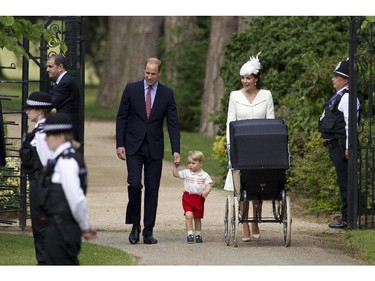 Britain's Prince William, Kate the Duchess of Cambridge, their son Prince George and daughter Princess Charlotte in a pram arrive for Charlotte's Christening at St. Mary Magdalene Church in Sandringham, England, Sunday, July 5, 2015.