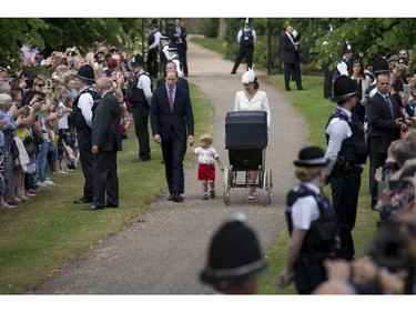 Britain's Prince William, Kate the Duchess of Cambridge, their son Prince George and daughter Princess Charlotte in a pram arrive for Charlotte's Christening at St. Mary Magdalene Church in Sandringham, England, Sunday, July 5, 2015.