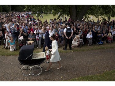 Britain's Prince William, Kate the Duchess of Cambridge, with son Prince George and daughter Princess Charlotte in a pram arrive for Charlotte's Christening at St. Mary Magdalene Church in Sandringham, England, Sunday, July 5, 2015.