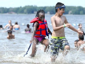 Swimmers play in the water at Britannia Beach in July. Like all four of Ottawa's beaches, Britannia will officially close on Aug. 28 this year.