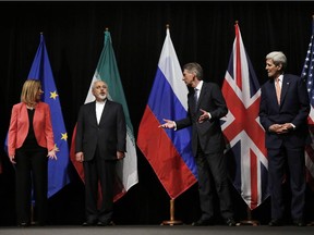 British Foreign Secretary Philip Hammond, 2nd right, U.S. Secretary of State John Kerry, right, and European Union High Representative for Foreign Affairs and Security Policy Federica Mogherini, left, talk to Iranian Foreign Minister Mohammad Javad Zarif as the wait for Russian at the Vienna International Center in Vienna, Austria, Tuesday, July 14, 2015.