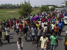 Mourners carry the coffin of Emmanuel Ndere Yimana, an opposition supporter who was assassinated overnight, during a funeral procession to a cemetery in Bujumbura on July 23, 2015. Burundian security forces crushed anti-government demonstrations, including shooting protesters running away from them, to silence those opposed to President Pierre Nkurunziza bid for a third-term, rights group Amnesty International said on July 23.