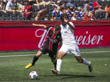 Carl Haworth (L) of the Ottawa Fury FC vies for the ball with Carolina RailHawks Nazmi Albadawi (R) during the teams NASL game at TD Place in Ottawa, July 26, 2015.