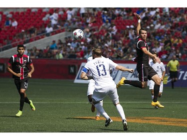 Carl Haworth  (R) of the Ottawa Fury FC heads the ball past Carolina RailHawks Connor Tobin (c) during the teams NASL game at TD Place in Ottawa, July 26, 2015.