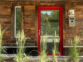 Charred eastern white cedar, a vivid contrast to the rest of the cladding, pulls the eye toward the entryway, which might have disappeared had another material been used. Also used for the planter that gives a bit of privacy from the nearby street, the cedar enhances the pop of the red posts and door frame. Asked how it’s charred, Rollo says, “We just take a torch to it.”