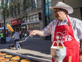 Mayor Naheed Nenshi flips a pancake at Calgary Economic Development sixth annual First Flip on Stephen Avenue in Calgary on Thursday, July 2, 2015.
