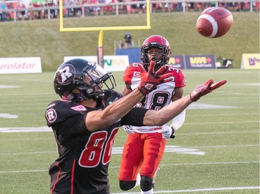 Chris Williams has glorious chance to make a touchdown with Calgary player Buddy Jackson looking on but drops the ball.