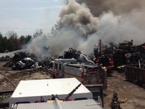 Firefighters work on a fire at a large scrapyard in Stittsville on Wednesday.