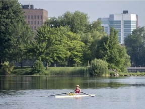 Clive Doucette passes the Arboretum as he goes for a row in his single scull on Dow's Lake in Ottawa on Tuesday, July 8, 2014.