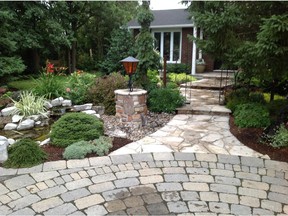 Things that work: natural stone, like this flagstone walkway, trees and easy-care shrubbery are key in this design by landscape architect Eva Schmitz of Artistic Landscape Design.