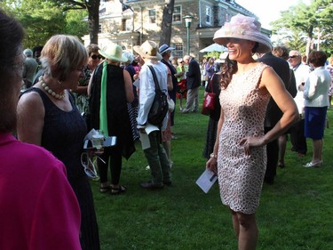 Earlene's House of Fashion volunteer model Nadine Sabine attracted attention as she circulated through the crowd at the 20th Annual Garden Party for Opera Lyra Ottawa, held at the official residence of the Italian ambassador in Gatineau on Wednesday, July 8, 2015.